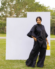 Load image into Gallery viewer, PRODUCT DESCRIPTION  2-piece co-ord set Button down shirt Bishop collar Front pocket detail on top Midi bell sleeve with frills Ruffle trim wide leg pants Side pockets Colour - Black
