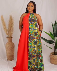 African print maxi dress with a fusion of crepe and ankara prints in front and crepe only behind. The dress has a velvet neckline detail and side pockets.  Model is wearing size 14.