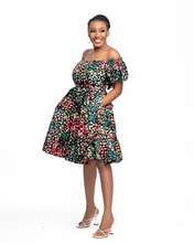 Load image into Gallery viewer, Heba is an off-shoulder African print (Ankara) mini dress with an elasticized puffed sleeve, a fitted bodice, tie-back details, and two-step gathers. Of course, like most FA dresses, she comes with pockets.  The model is wearing a size 12.
