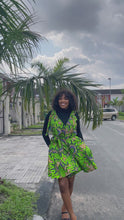 Load and play video in Gallery viewer, African print dress with side pockets, tie and single front button detail.  The model is wearing a size 12
